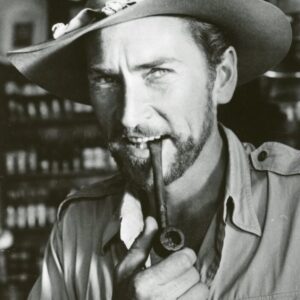 Actor Robin Hughes with jungle hat and pipe