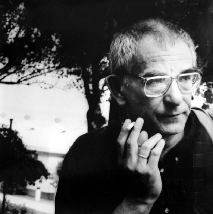 Director Krzysztof Kieslowsky looking serious, holding a cigarette