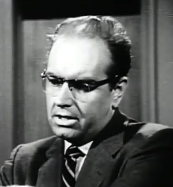 Television still of actor Parley Baer wearing glasses, suit and tie