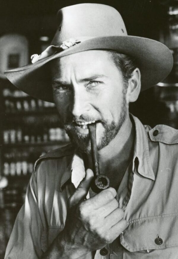 Actor Robin Hughes with jungle hat and pipe
