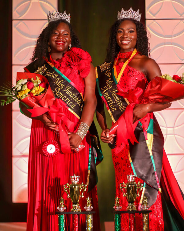 Photo of two newly crowned African American beauty pageant winners smiling